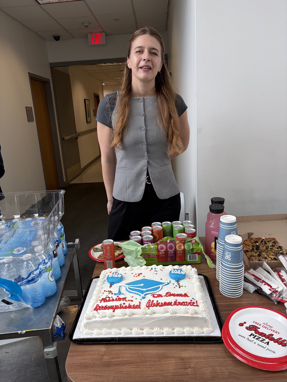 Emma Aleksandrovic beside the Mission Accomplished celebration cake